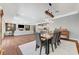 Open-concept dining area featuring a unique wood table and seating, seamlessly connecting to the living room and kitchen at 5913 Audria Falls Ave, Las Vegas, NV 89131
