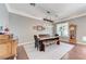 Elegant dining room features modern lighting, a large table, and ample space for hosting gatherings and creating memories at 5913 Audria Falls Ave, Las Vegas, NV 89131