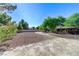 Circular driveway featuring desert landscaping, mature trees, and ample parking at 5913 Audria Falls Ave, Las Vegas, NV 89131