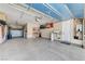 Spacious three-car garage with epoxy flooring and ample storage, perfect for vehicles and hobbies at 5913 Audria Falls Ave, Las Vegas, NV 89131