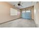 Clean, well-lit two-car garage featuring epoxy flooring and a window for natural light at 5913 Audria Falls Ave, Las Vegas, NV 89131