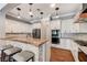Stylish kitchen with white cabinets, stainless steel appliances, a breakfast bar, and modern lighting at 5913 Audria Falls Ave, Las Vegas, NV 89131