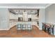Modern kitchen with white cabinets, stainless appliances, island with seating, and wood-look countertops at 5913 Audria Falls Ave, Las Vegas, NV 89131