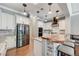 Updated kitchen featuring stainless steel appliances, island with live-edge counter, and ample storage space at 5913 Audria Falls Ave, Las Vegas, NV 89131