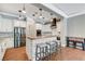 Modern kitchen features stainless steel appliances, a center island with bar seating, and elegant white cabinetry at 5913 Audria Falls Ave, Las Vegas, NV 89131