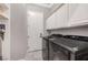Well-lit laundry room featuring modern appliances, white cabinetry, and convenient storage space at 5913 Audria Falls Ave, Las Vegas, NV 89131