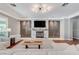 Stylish living room boasts a unique fireplace, modern lighting, and a comfortable seating area for relaxing and entertaining at 5913 Audria Falls Ave, Las Vegas, NV 89131