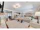 Elegant living room featuring a modern fireplace, stylish decor, and an open layout connecting the kitchen and dining areas at 5913 Audria Falls Ave, Las Vegas, NV 89131