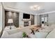 Well-appointed living room with a chic fireplace, modern decor, and ample seating for cozy gatherings at 5913 Audria Falls Ave, Las Vegas, NV 89131