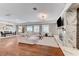 Open living space featuring a modern fireplace, spacious seating, and bright lighting at 5913 Audria Falls Ave, Las Vegas, NV 89131