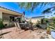 Outdoor kitchen and dining area with seating for six offer a delightful space for entertaining and enjoying the outdoors at 5913 Audria Falls Ave, Las Vegas, NV 89131