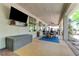 Relaxing covered patio area features a built-in television, seating and ceiling fans at 5913 Audria Falls Ave, Las Vegas, NV 89131