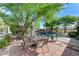 Patio with outdoor dining, mature trees, and an inviting pool and spa at 5913 Audria Falls Ave, Las Vegas, NV 89131