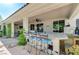 Entertain on this gorgeous patio with bar, sink, and seating with ceiling fans at 5913 Audria Falls Ave, Las Vegas, NV 89131