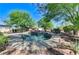 Inviting pool and spa surrounded by mature landscaping create a serene retreat at 5913 Audria Falls Ave, Las Vegas, NV 89131