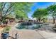 Beautiful swimming pool and mature trees create a backyard oasis perfect for entertaining at 5913 Audria Falls Ave, Las Vegas, NV 89131