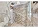 Walk-in shower with grey tile and a pebble floor is luxurious and stylish at 5913 Audria Falls Ave, Las Vegas, NV 89131