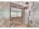 A stylish walk-in shower with decorative wall tiling, seating and a view at 5913 Audria Falls Ave, Las Vegas, NV 89131