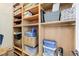 Spacious walk-in closet featuring custom wooden shelving and ample storage space for organization at 5913 Audria Falls Ave, Las Vegas, NV 89131