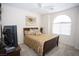Cozy bedroom with natural light, a comfortable bed, and a ceiling fan at 5935 Saddle Horse Ave, Las Vegas, NV 89122