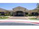 Beautiful clubhouse entrance with stone accents, professional landscaping, and an arched entry at 5935 Saddle Horse Ave, Las Vegas, NV 89122