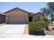 Charming single-story home featuring desert landscaping, a two-car garage, and a welcoming entryway at 5935 Saddle Horse Ave, Las Vegas, NV 89122