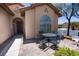 Cozy front patio with outdoor seating and a view of the home's charming architecture at 5935 Saddle Horse Ave, Las Vegas, NV 89122