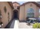 Inviting front porch featuring a seating area, a secure front door, and well-maintained landscaping at 5935 Saddle Horse Ave, Las Vegas, NV 89122