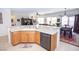Open kitchen with counter seating, stainless appliances, and seamless flow to dining and living areas at 5935 Saddle Horse Ave, Las Vegas, NV 89122