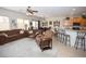 Spacious living room featuring plush seating, a cozy atmosphere, and an open layout to the kitchen at 5935 Saddle Horse Ave, Las Vegas, NV 89122