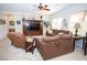 Comfortable living room with plush furniture, ceiling fan, and entertainment center at 5935 Saddle Horse Ave, Las Vegas, NV 89122