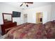 Spacious main bedroom featuring a ceiling fan, television, and ensuite bathroom access at 5935 Saddle Horse Ave, Las Vegas, NV 89122