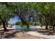 A scenic pond with mature trees and a walking path offers a peaceful escape within the community at 5935 Saddle Horse Ave, Las Vegas, NV 89122
