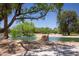 Scenic pond with a golf course in the distance, surrounded by mature trees and lush vegetation at 5935 Saddle Horse Ave, Las Vegas, NV 89122