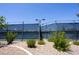 A view of the community tennis courts with windscreens and manicured landscaping at Solera at 5935 Saddle Horse Ave, Las Vegas, NV 89122