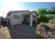 An alternate view of a gravel-covered backyard with a covered patio and low-maintenance desert landscaping at 6040 Eganridge Ct, North Las Vegas, NV 89081