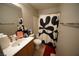 Bathroom features a single sink vanity, toilet, and shower/tub with black and white curtain at 6040 Eganridge Ct, North Las Vegas, NV 89081