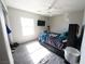 Bedroom with neutral walls, carpeted floors, and a ceiling fan for comfort and air circulation at 6040 Eganridge Ct, North Las Vegas, NV 89081
