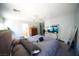 View of a neutral-toned bedroom with a ceiling fan and TV in the corner at 6040 Eganridge Ct, North Las Vegas, NV 89081