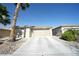 Single-story home features a two-car garage, desert landscaping, and paved driveway at 6040 Eganridge Ct, North Las Vegas, NV 89081