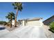 Single-story home with desert landscaping, large driveway, and an attached garage at 6040 Eganridge Ct, North Las Vegas, NV 89081