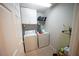 Functional laundry room with washer, dryer, storage shelving and tile floors at 6040 Eganridge Ct, North Las Vegas, NV 89081