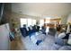 Open-concept living room featuring a blue sofa and view of the kitchen at 6040 Eganridge Ct, North Las Vegas, NV 89081