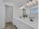 Well-lit bathroom with double sinks, quartz countertops, and modern fixtures at 6112 Blossom Knoll Ave, Las Vegas, NV 89108