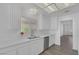 Bright kitchen with white cabinets, stainless steel appliances, modern faucet, and wood-style flooring at 6112 Blossom Knoll Ave, Las Vegas, NV 89108