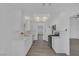 Modern kitchen with white cabinets, quartz countertops, stainless steel appliances, and wood-style flooring at 6112 Blossom Knoll Ave, Las Vegas, NV 89108