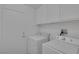 Functional laundry room featuring washer, dryer, and storage cabinets at 6112 Blossom Knoll Ave, Las Vegas, NV 89108