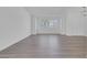Spacious living room featuring wood-style flooring, modern light fixture, and lots of natural light at 6112 Blossom Knoll Ave, Las Vegas, NV 89108