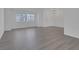 Spacious living room featuring wood-style flooring, modern light fixture, and lots of natural light at 6112 Blossom Knoll Ave, Las Vegas, NV 89108