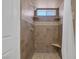 Tiled walk-in shower with window, corner seats, and decorative tile accents at 6112 Blossom Knoll Ave, Las Vegas, NV 89108